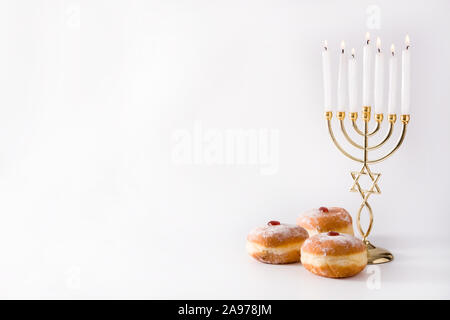 Jewish Hanukkah menorah and sufganiyot donuts isolated on white background. Copy space Stock Photo