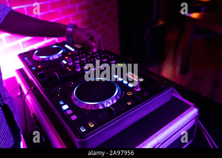 DJ playing music.Midi controller turntable.New digital technology for mixing audio tracks.Sound mixer with turntables.Disc jockey mix music at party Stock Photo