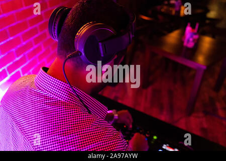 the DJ behind work in night club Stock Photo