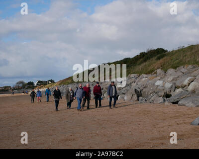 Group of people walking on the beach Stock Photo