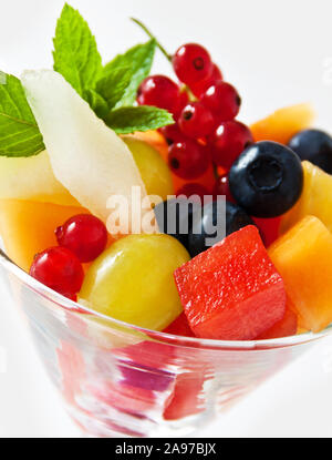 Delicious fruit salad in plastic cup on white background Stock Photo - Alamy