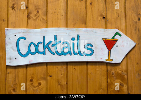 A sign pointing the direction to buy cocktails. Stock Photo