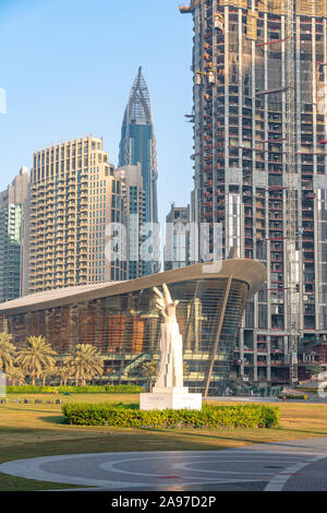 The hand statue in Burj Park with the Dubai Opera and construction in the background.