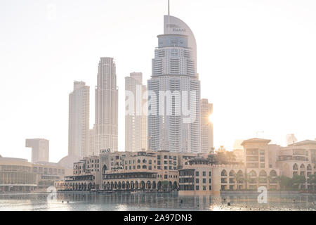 Sunrising behind the high-rise buildings near the Dubai Mall in Downtown Dubai. Stock Photo