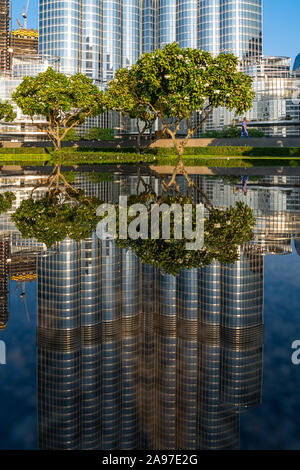Stunning reflection of the Burj Khalifa and landscaping in a reflective pond near the Dubai Mall in Downtown Dubai, United Arab Emirates. Stock Photo