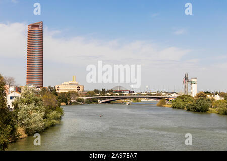 Seville, Spain. Views of River Guadalquivir with the Sevilla Tower or Pelli Tower, the Puente Cristo de la Expiracion bridge and the Schindler Tower Stock Photo