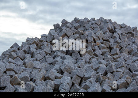 A big pile of European square cobblestones has been placed on a construction site in Malmö, Sweden. Has copy space. Stock Photo