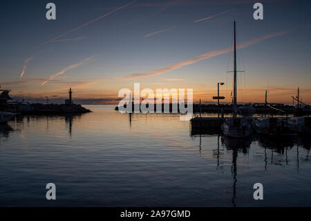 Sunrise over Cala Bona Majorca Marina full of vibrant colours and the promise of a beautiful day. Stock Photo