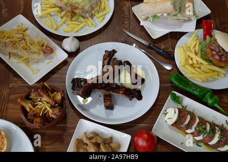 Wide variety of Mediterranean food presented on the common wooden table. image taken from above Stock Photo