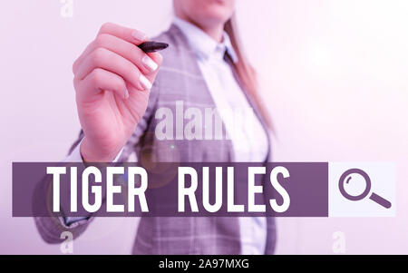 Handwriting text writing Tiger Rules. Conceptual photo Willpower and demonstratingal strength Resistance to imperial rule Business woman pointing in e Stock Photo