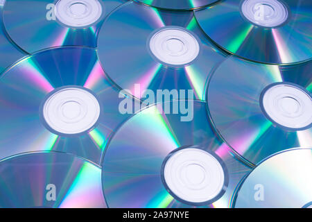 A shot of shiny CDs or DVDs, over a white background. Stock Photo