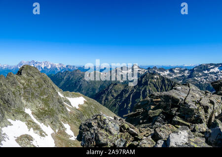 Massive mountain range of Schladming Alps, Austria. The slopes of Alps are steep, partially overgrown with green bushes. Dangerous mountain climbing.C Stock Photo