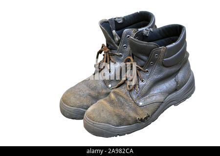 He heavily used work boots on rough terrain. Hole. Isolated on a white background. Stock Photo
