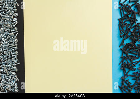 Flat Lay Composition With Different Screws on Black, Yellow and Blue Background. Top View of Checklist Concept Stock Photo
