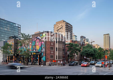 Antoine Tava and Leonard Cohen mural at dusk, De Maisonneuve boulevard / Bishop Street Corner, Downtown Montreal, Quebec, Canada Stock Photo