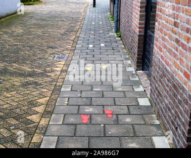 Sidewalk with painted colorful footsteps for children outside Stock Photo