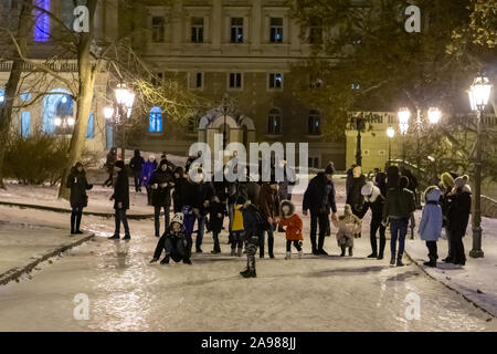 On an improvised ice slide, the inhabitants of the city ride on ice Stock Photo