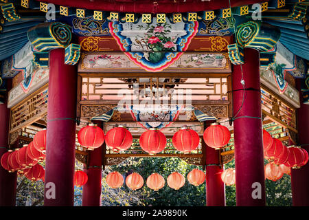 The sun shines on lamps from behind a gazebo at Chinatown in Yokohama, Japan. Stock Photo