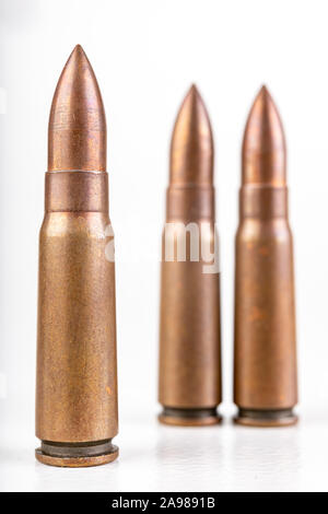 Machine gun cartridges. Military ammunition used in Soviet weapons. White background. Stock Photo