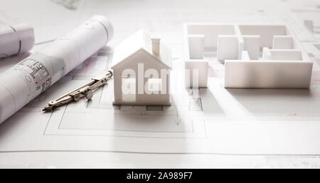 House model and blueprint plans, residential building project architectural design, closeup view Stock Photo