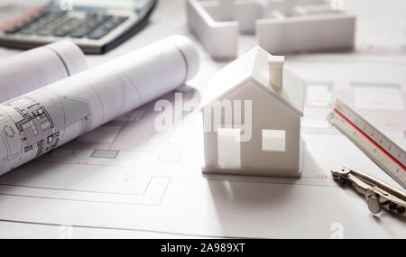 House model and blueprint plans, residential building project architectural design, closeup view Stock Photo