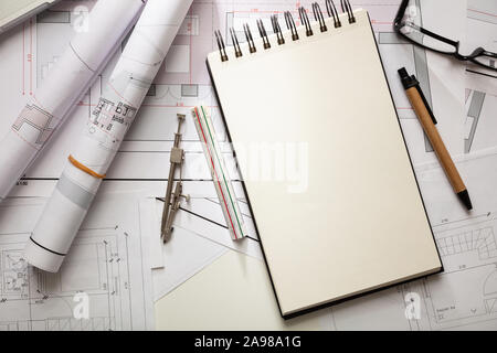 Architect engineer office desk. Blueprint plans, blank notepad and office supplies, copy space, top view Stock Photo