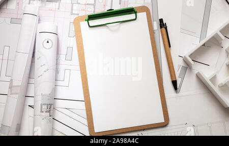 Architect engineer office desk. Blueprint plans, blank clipboard and office supplies, copy space, top view Stock Photo