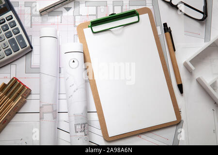Architect engineer office desk. Blueprint plans, blank clipboard and office supplies, copy space, top view Stock Photo