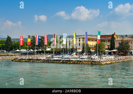 CISANO, LAKE GARDA, ITALY - SEPTEMBER 2018: Flags of Member States of the European Union around the small marina in Cisano on Lake Garda. Stock Photo