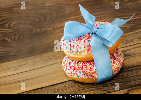 Donuts against wooden background Stock Photo