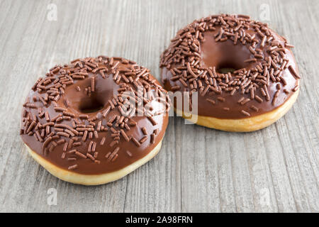 Two Donuts against wooden background Stock Photo