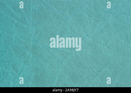 Rows of small loops, detal of knitted pattern, mint color, sackcloth or burlap with visible striped diagonal texture, for vivid background Stock Photo