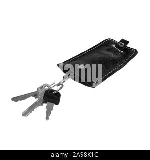 Ordinary black leather key case with three keys isolated on white background Stock Photo