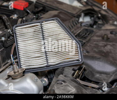 Dirty air filter for car engine filled with dirt, debris, and bugs. Concept of automobile maintenance and service Stock Photo