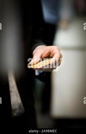 Credit card held in the hand of a businessman. Stock Photo