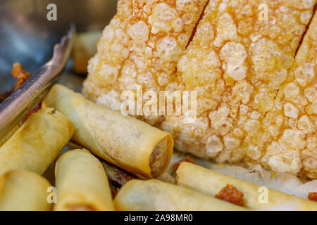 Close up view of asian style of crunchy and crispy spring roll and skin of belly pork. Stock Photo