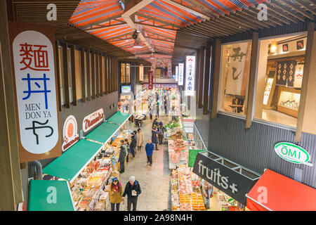 KANAZAWA, JAPAN - JANUARY 20, 2017: Early morning shoppers peruse fresh seafood at the the Omicho Market. Stock Photo