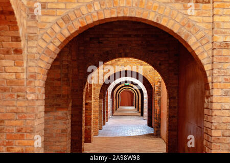 Archways leading down a corridor of a modern architectural structure in Australia - ideal for background Stock Photo