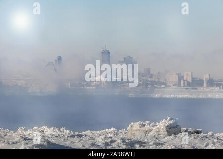 Quebec city in winter on a very freezing cold sunny day with sun behind fog clouds Stock Photo