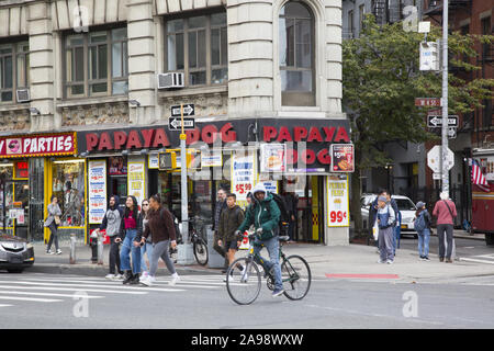 Man rides a bicycle along 6th Avenue at West 4th Street in the Greenwich Village  neighborhood in New York City. Stock Photo