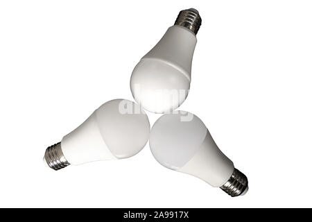 Three led bulb light and energy-saving lamp on table on white background. Energy saving concept Stock Photo