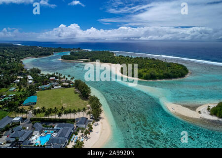 Beach club with blue swimming pool and palm trees on coast of Atlantic ...