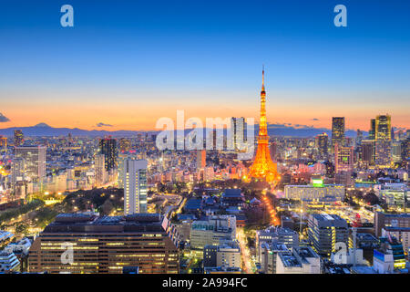 Tokyo, Japan downtown cityscape in the Minato Ward at dusk with the tower and Mt. Fuji in the distance on the horizon. Stock Photo