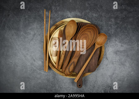 Natural kitchen tools wood products / Kitchen utensils background with spoon fork chopsticks plate cutting board object , top view on the table utensi Stock Photo