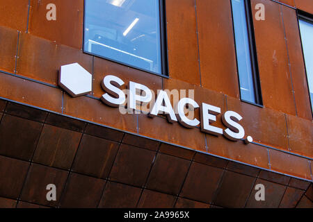 Spaces sign on the build. Co-working business where people can rent space to work at Stock Photo