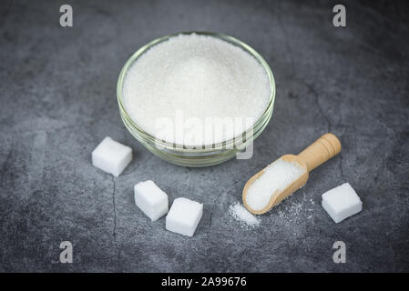 Sugar cubes and white sugar on bowl with gray background , top view Stock Photo
