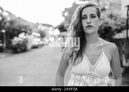 Young beautiful Hispanic tourist woman outdoors in black and white Stock Photo