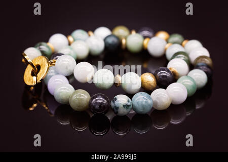 Beautiful jade necklace with gold clasp on black background Stock Photo