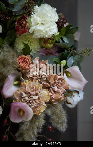 Close-up detail of a vintage bouquet in a round box on a dark background, selective focus Stock Photo