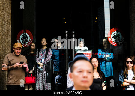 Hong Kong, China. 13th Nov, 2019. Bystanders stand and watch during a protest in the Central district Hong Kong. A 'Blossom Everywhere' action was organized by the protestors to paralyze traffic and vandalize things across Hong Kong for its third consecutive days and have sparked some of the worst violence in five months of unrest. Credit: SOPA Images Limited/Alamy Live News Stock Photo